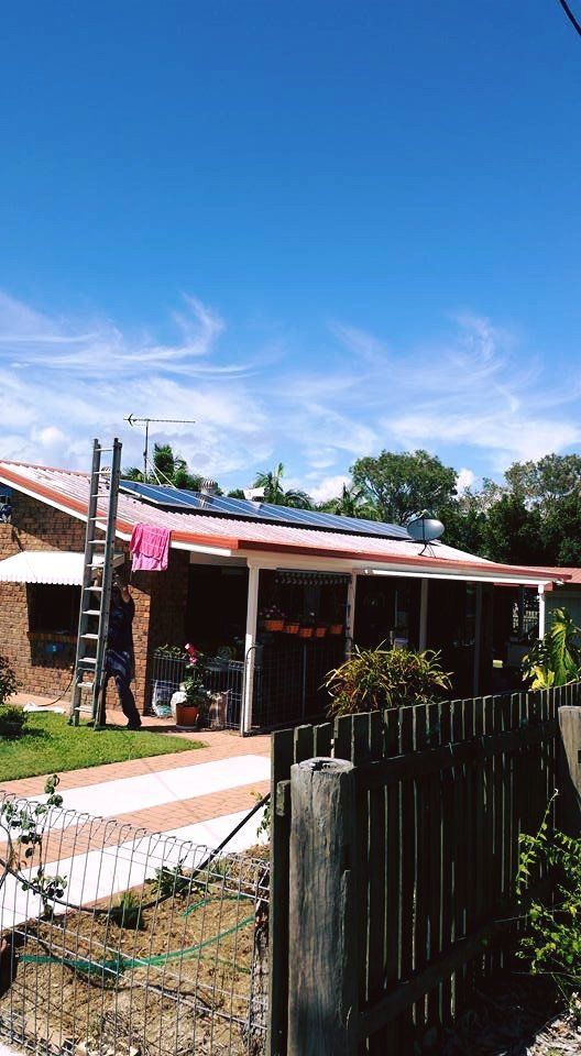 Man With Ladder Beside House With Solar Panels — Solar Panel Maintenance in Hervey Bay, QLD