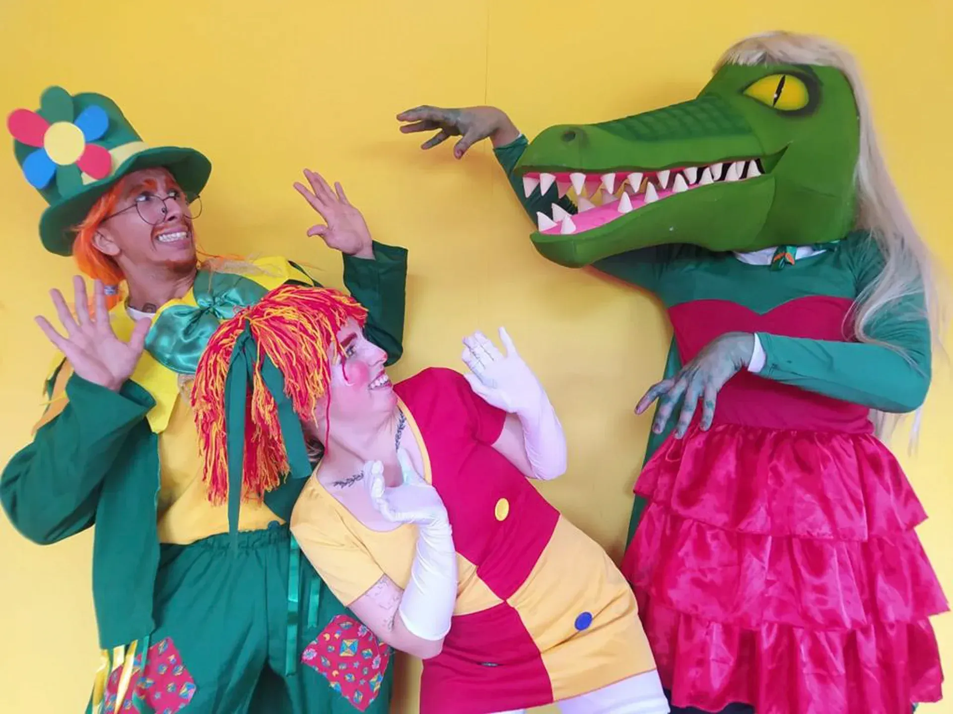 um grupo de pessoas vestidas com fantasias, incluindo um crocodilo