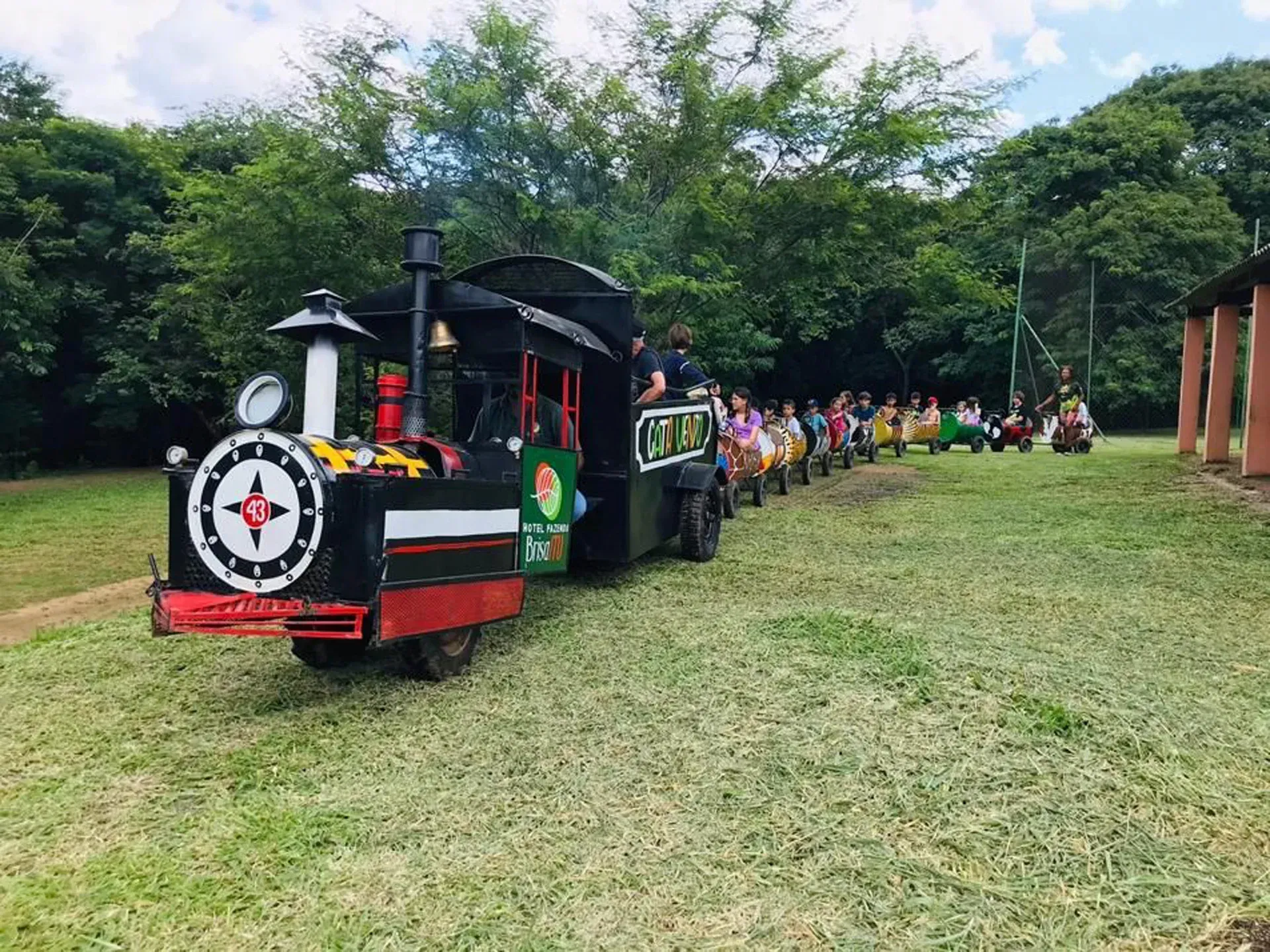 um grupo de pessoas está andando em um pequeno trem em um parque.