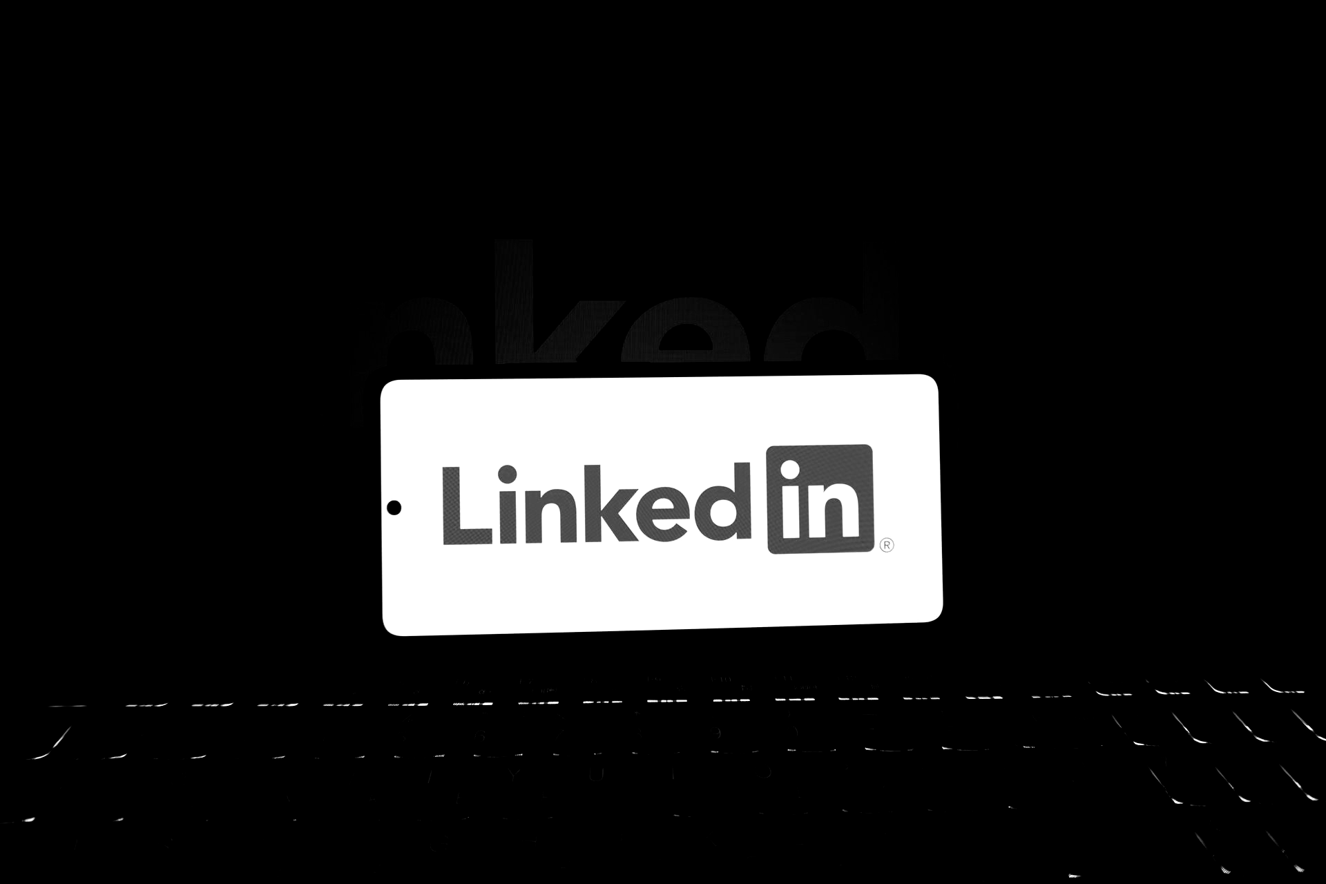 LinkedIn logo emerging from a dark background.