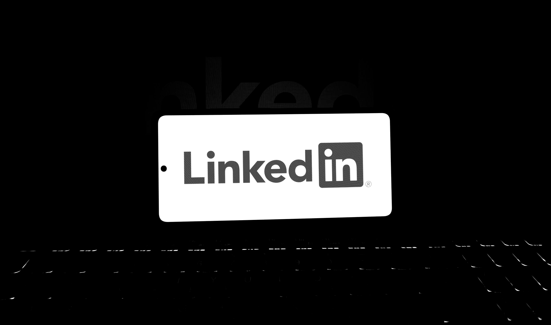 LinkedIn logo emerging from a dark background.