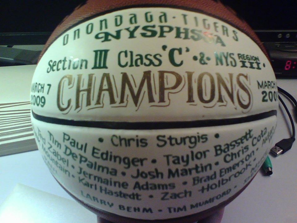 A basketball with the word champions on it