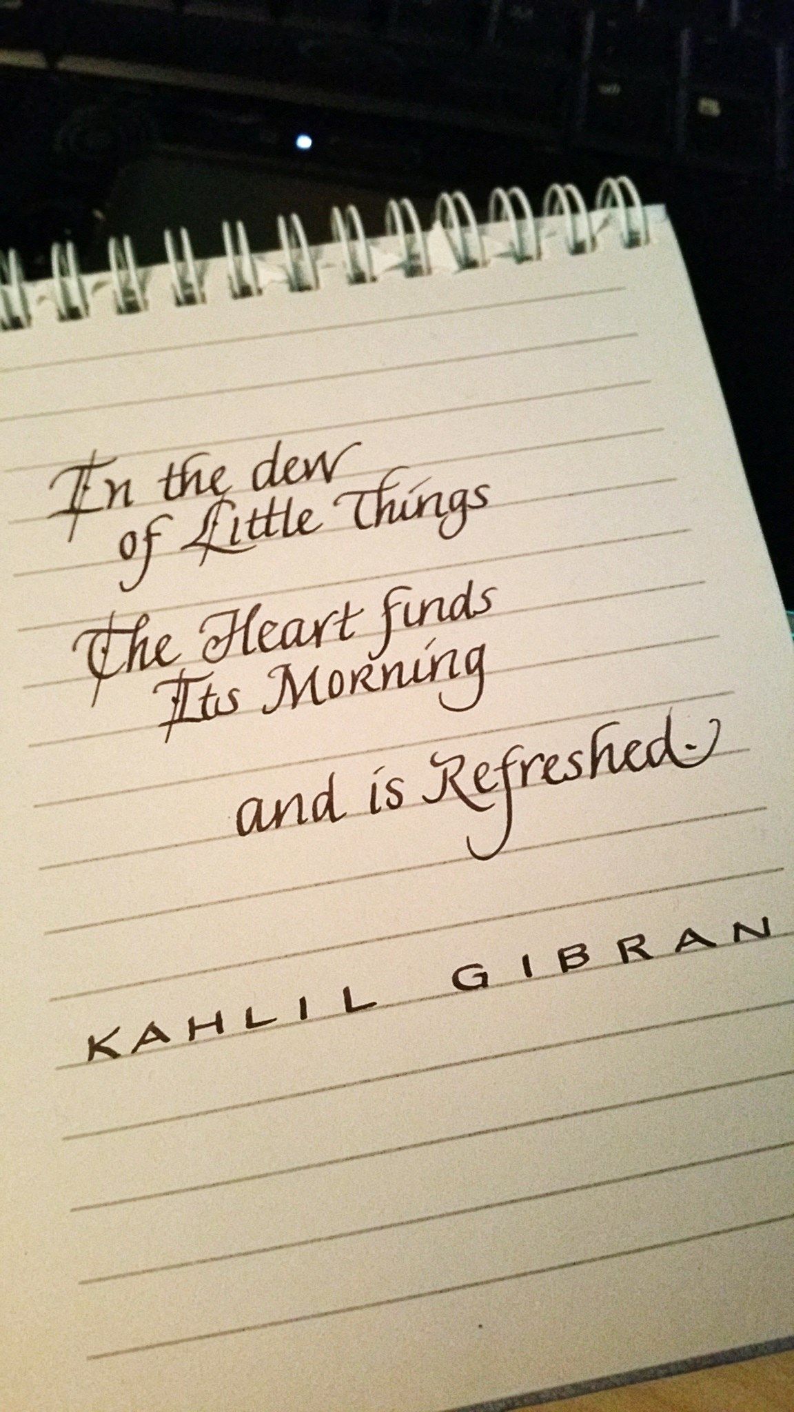 A notebook with a quote by kahlil gibran on it