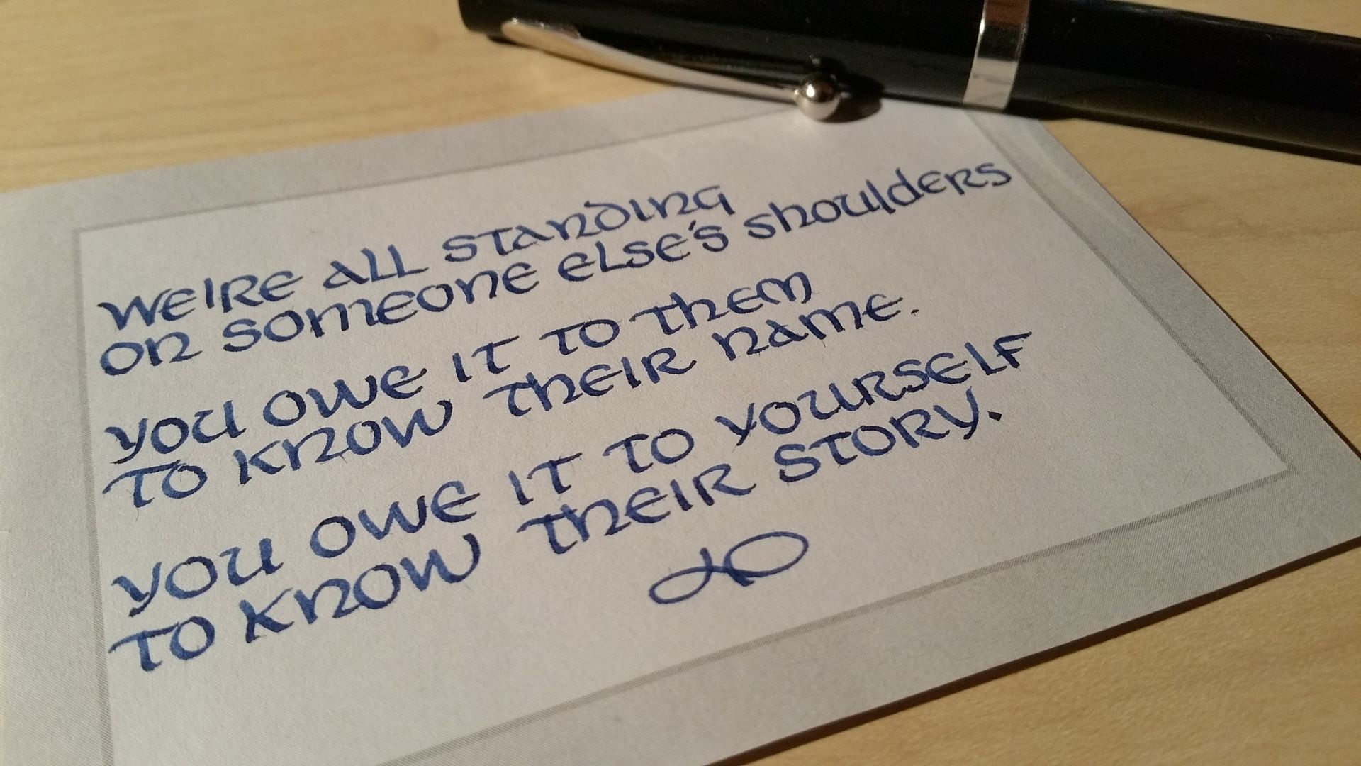 A piece of paper that says we 're all standing on someone else 's shoulders