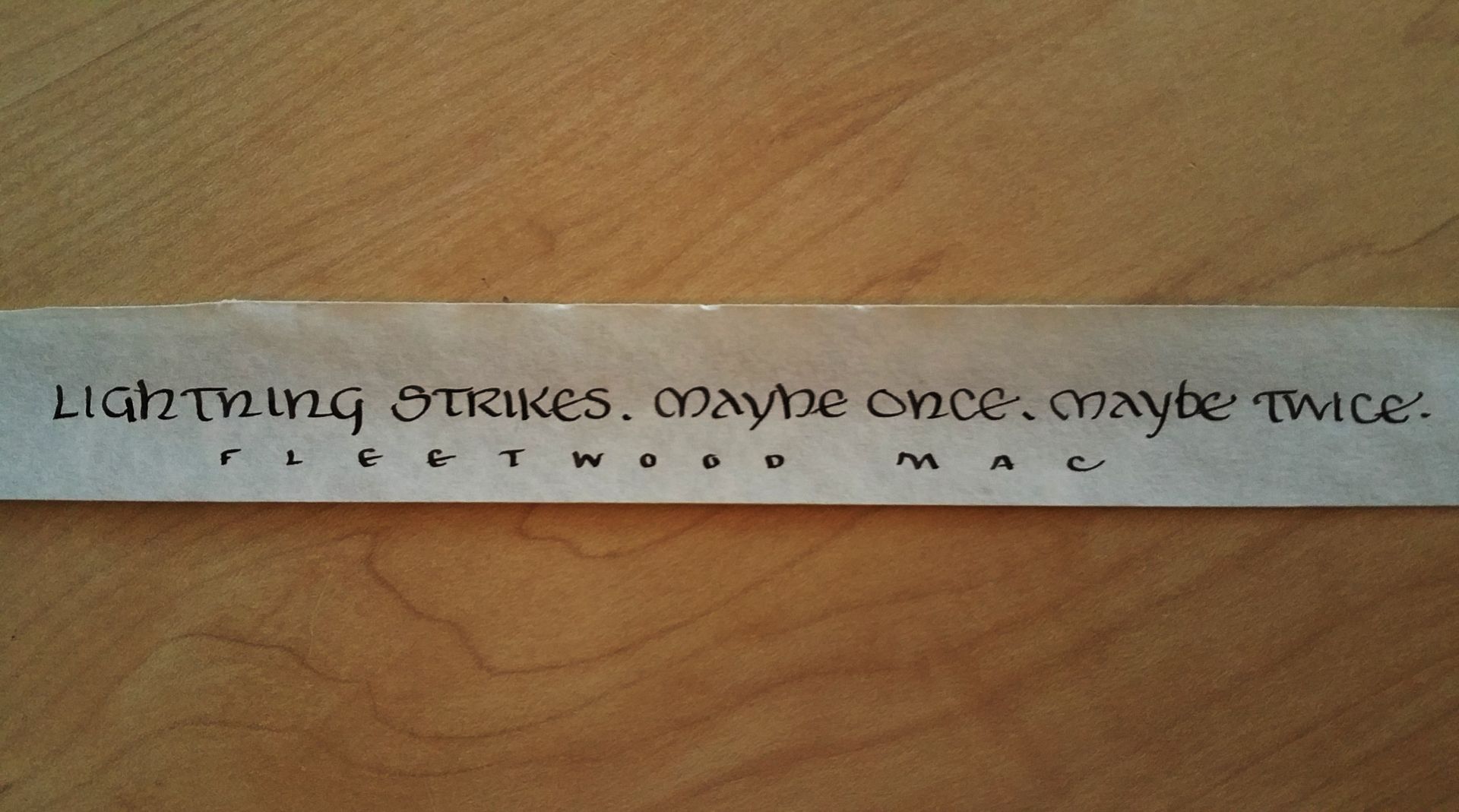 A piece of paper that says lightning strikes maybe once maybe twice