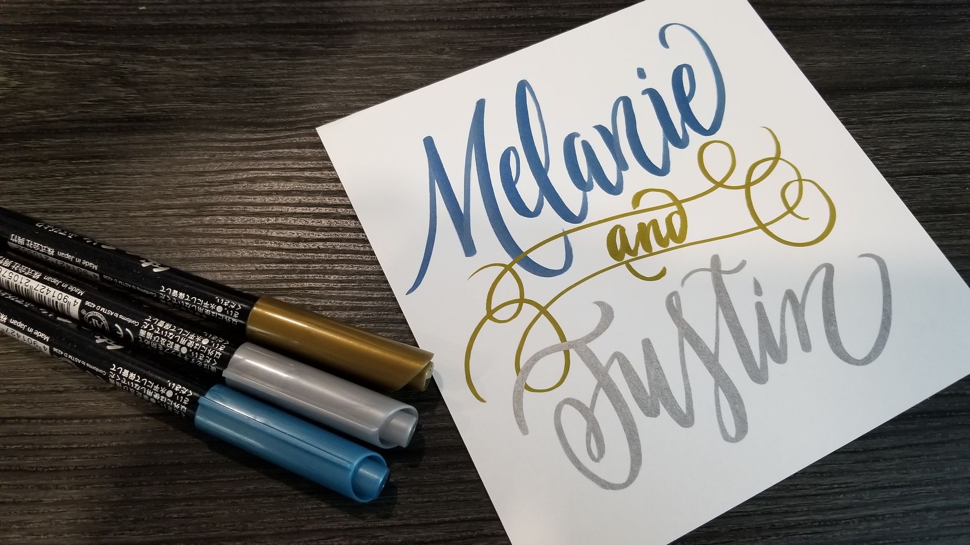 A piece of paper with the names melanie and justin written on it