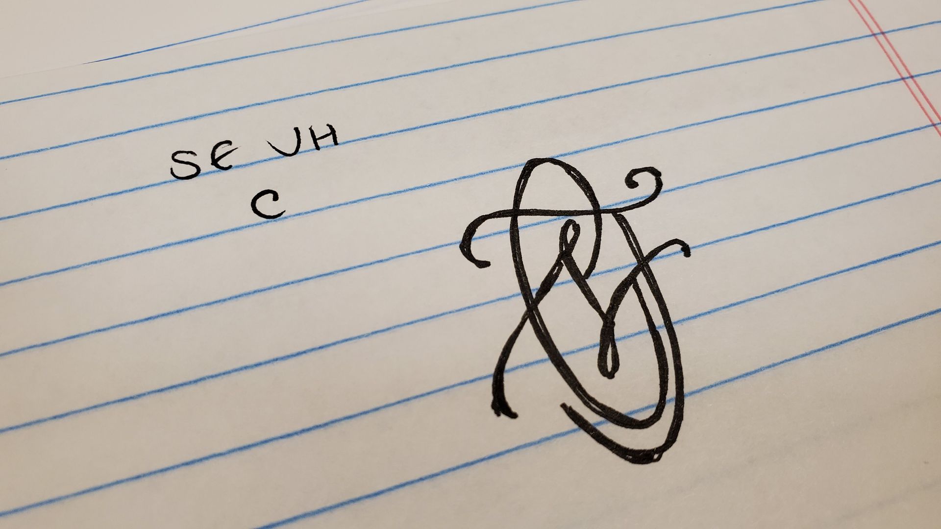 A piece of paper with the letters se jh written on it