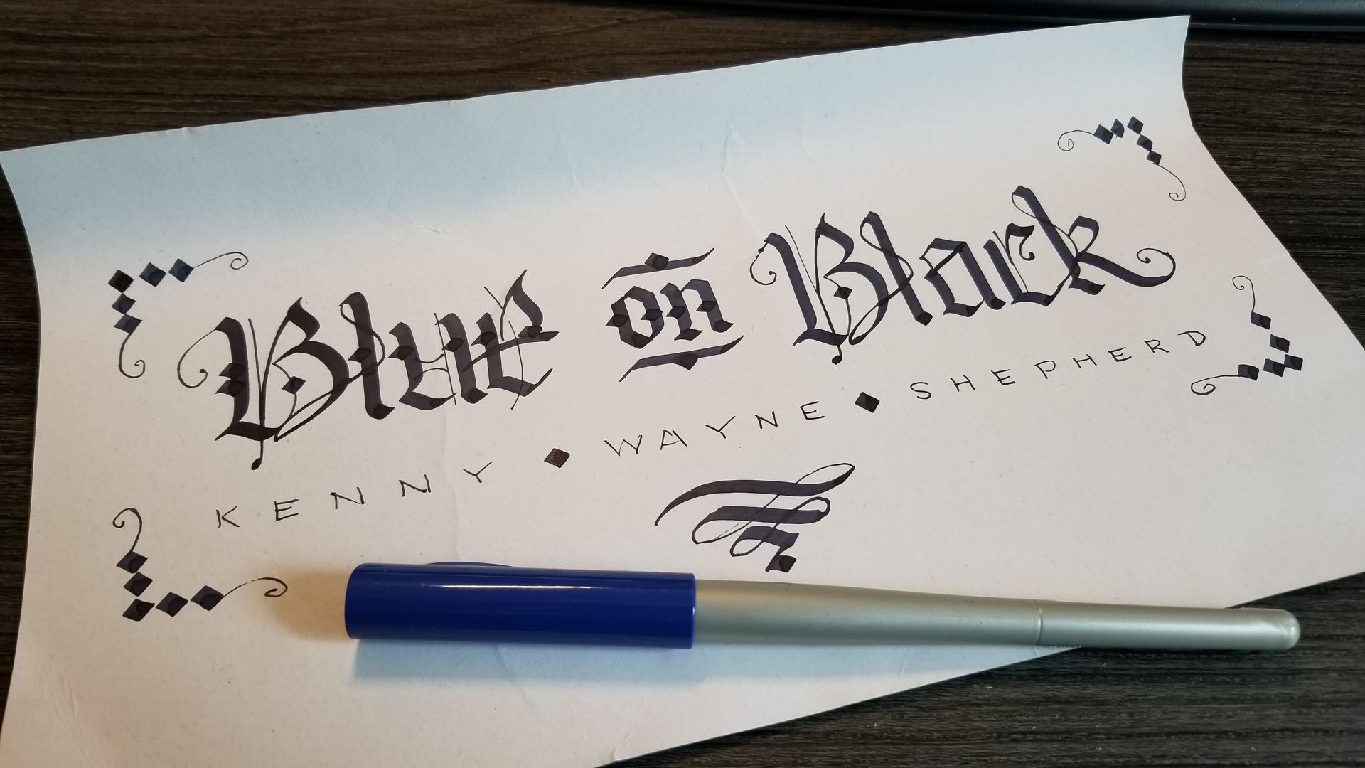 A piece of paper with the words blue on black written on it