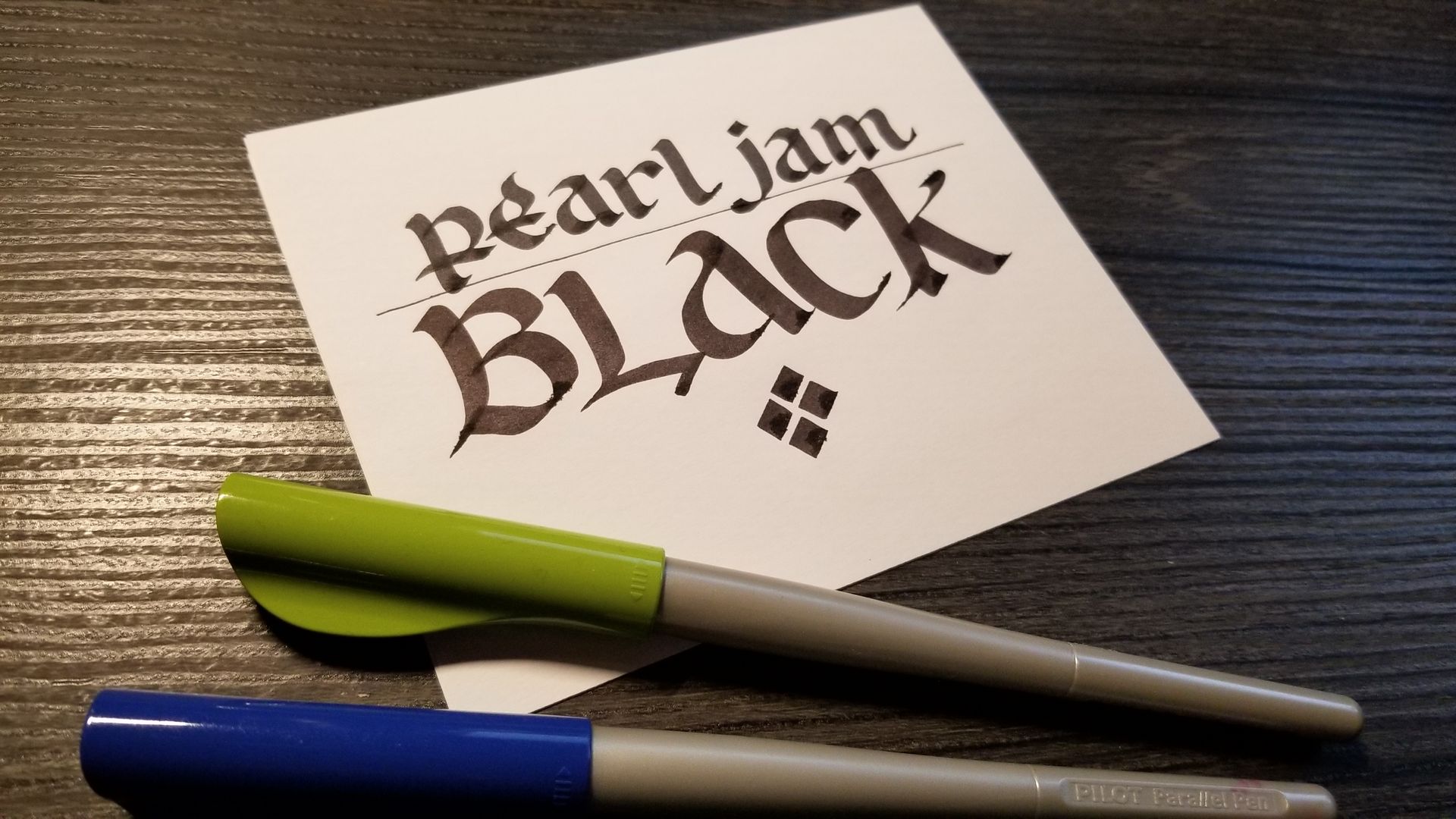 A piece of paper with pearl jam black written on it