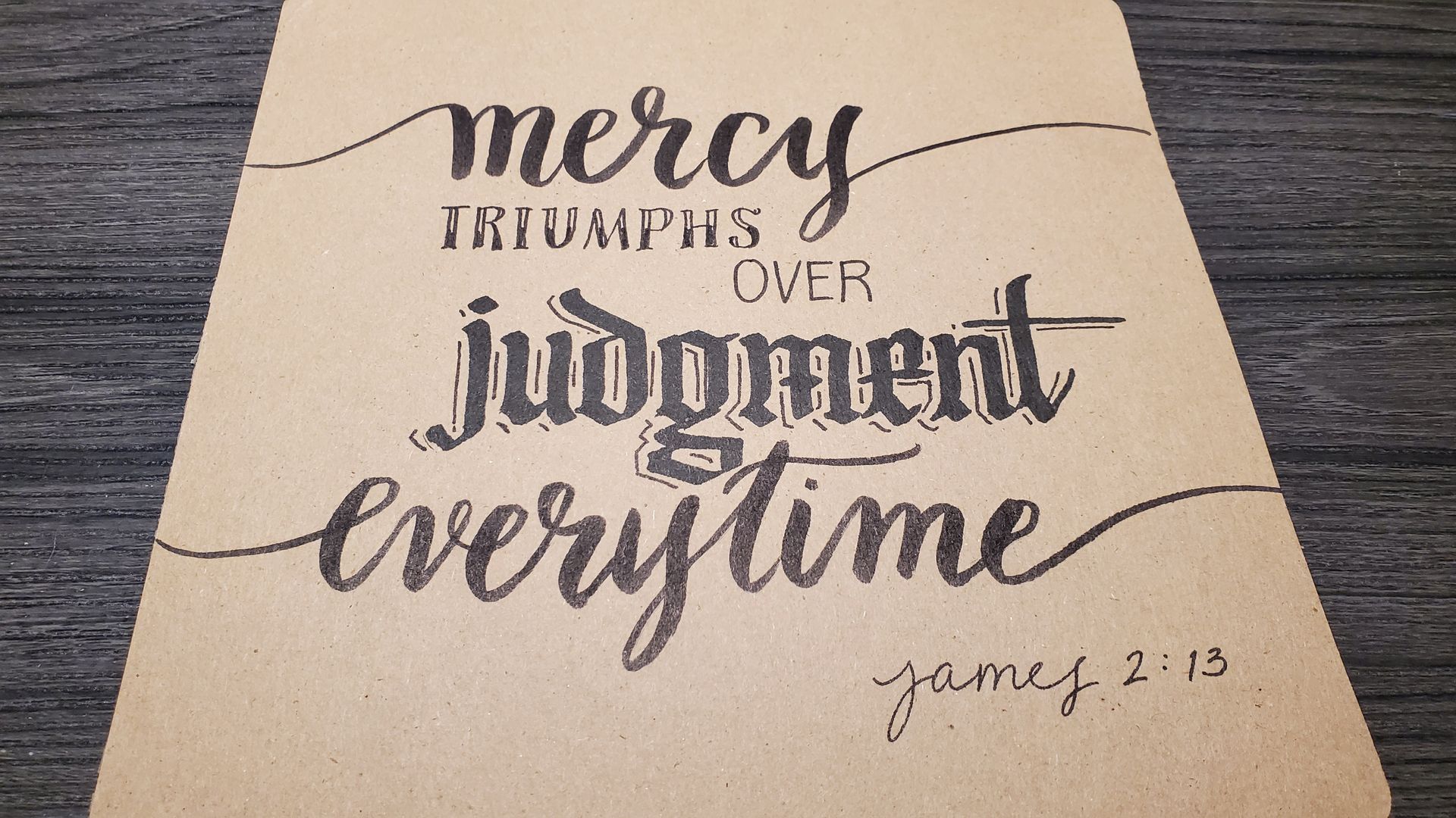 A piece of paper that says mercy triumphs over judgment every time