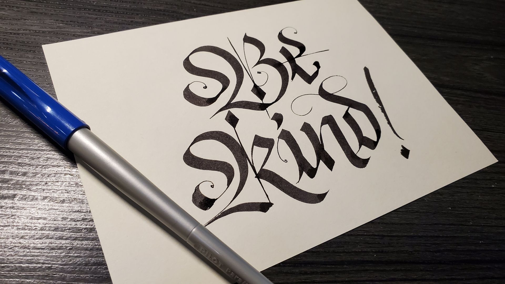 A piece of paper with the words be kind written on it