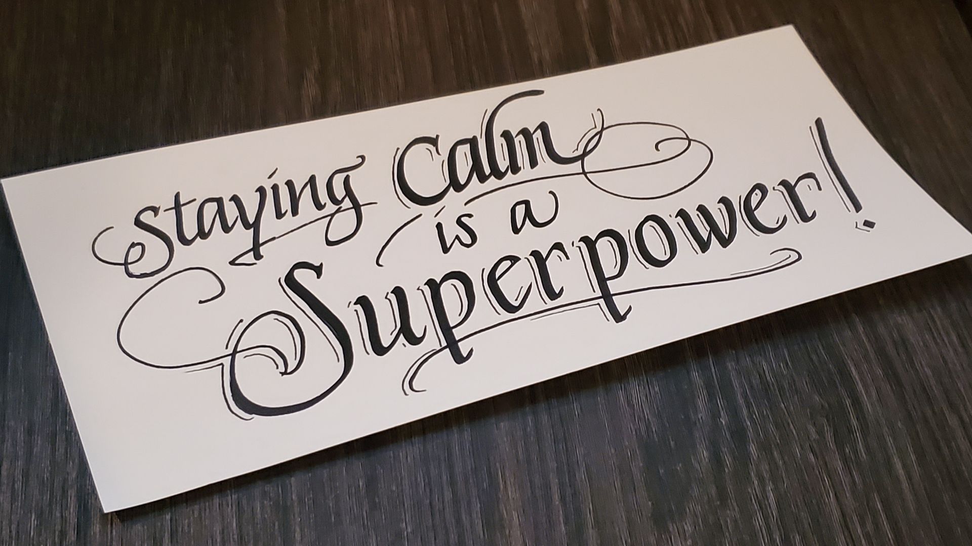 A piece of paper that says staying calm is a superpower