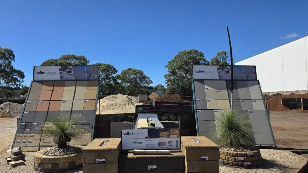 A display of tiles in a yard with trees in the background.