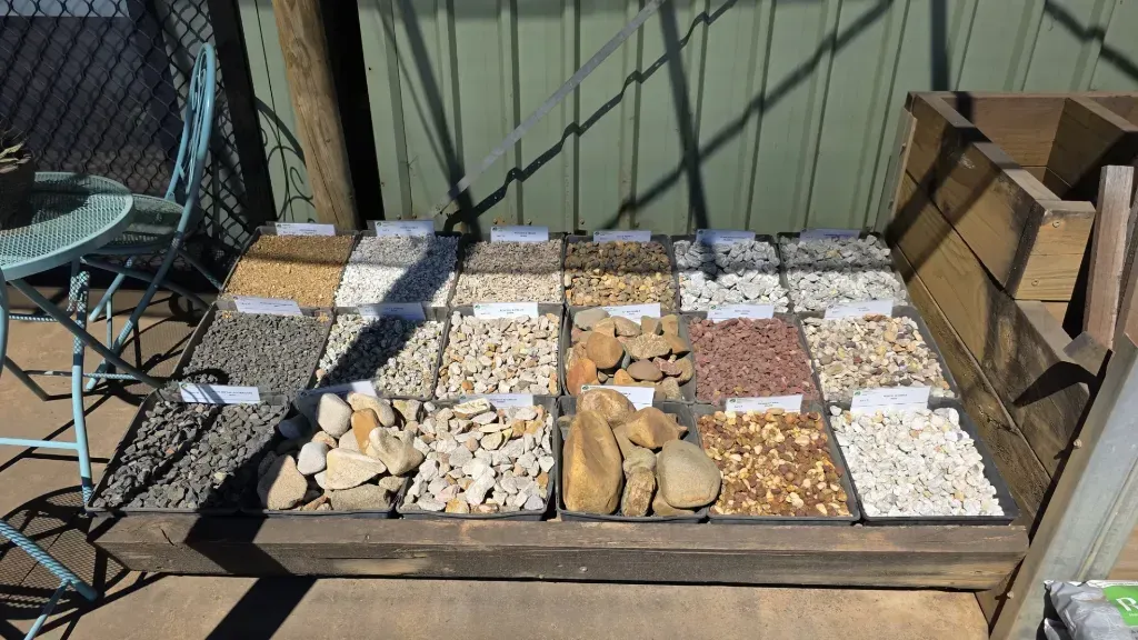 There are many different types of decorative pebbles and rocks on the table.