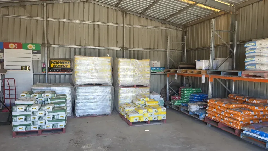 A warehouse filled with lots of bags and pallets.