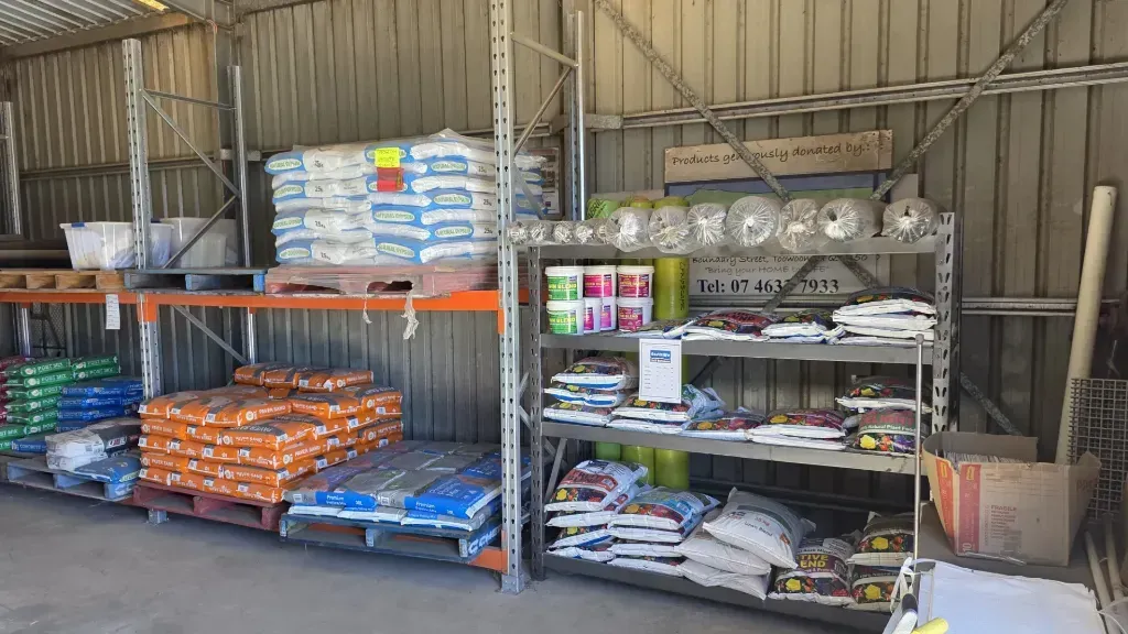 A warehouse filled with shelves filled with bags of fertiliser.