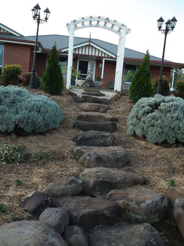 A brick house with a stone walkway leading to it
