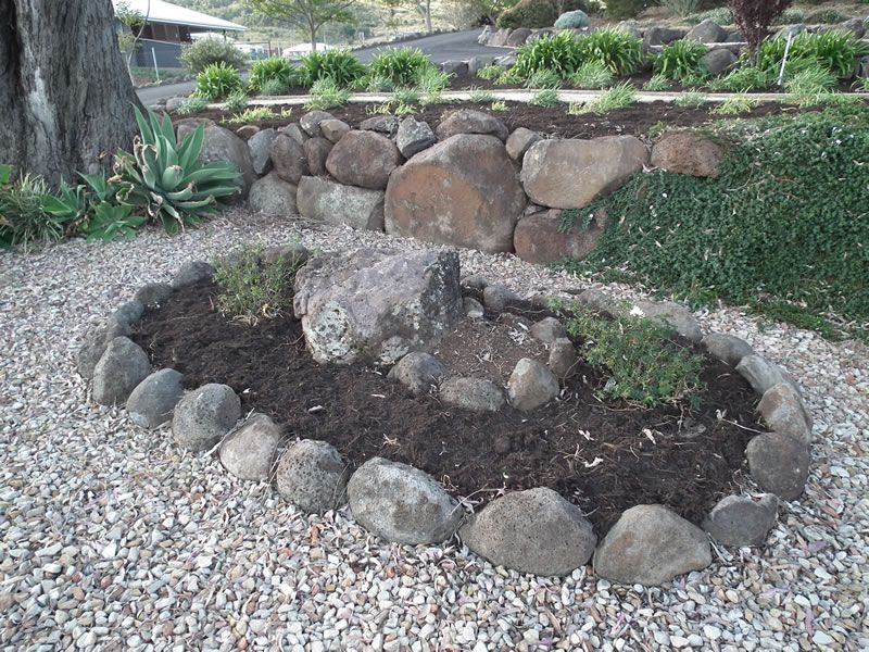 A rock garden with a tree in the background