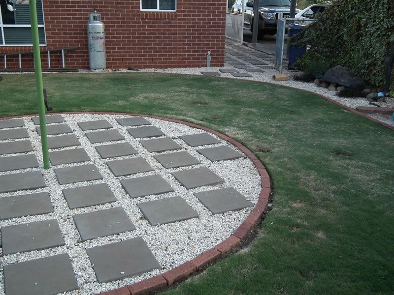 A brick building with a propane tank in the backyard