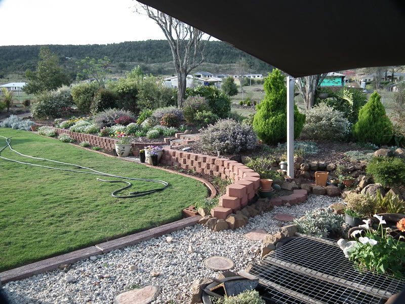 A view of a lush green garden from a patio