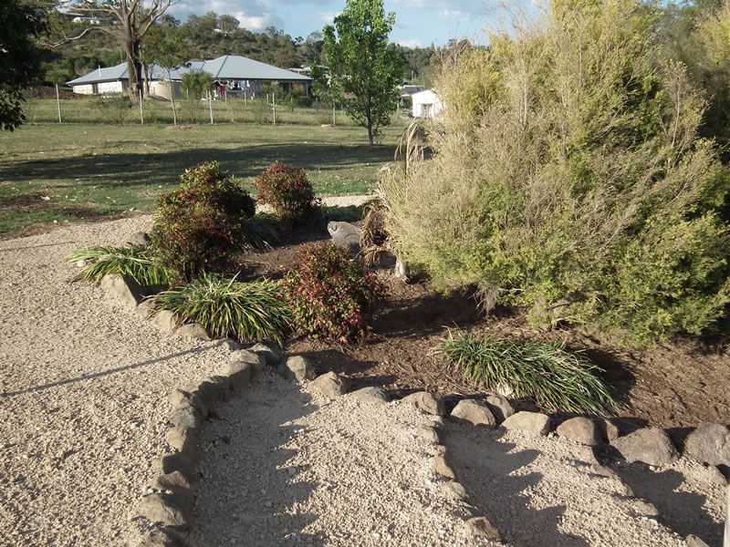 A gravel path with a house in the background