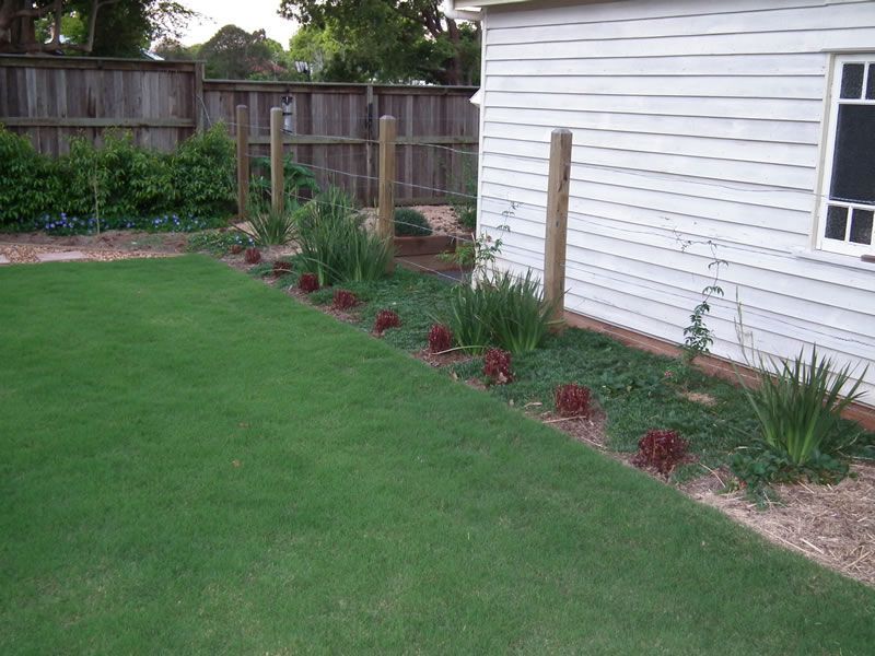 A white house with a large lawn in front of it