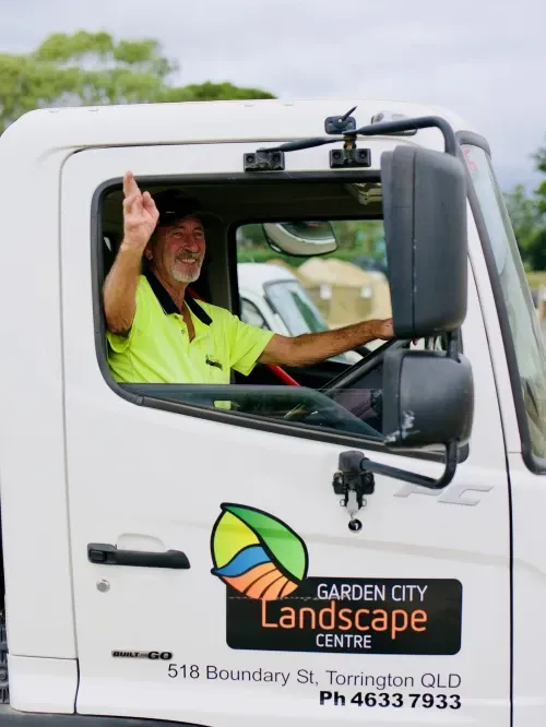 A man is driving a garden city landscape centre truck
