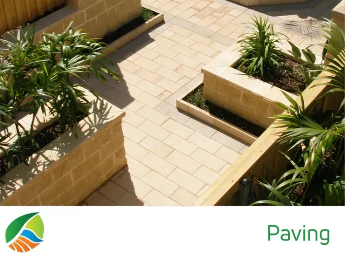 A sandstone pathway surrounded by rocks and mulch