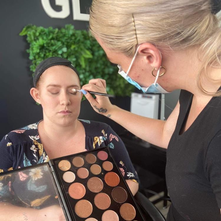 A close up of a woman 's face with blue eyes and long eyelashes — Glam Hair and Beauty in Woy Woy, NSW