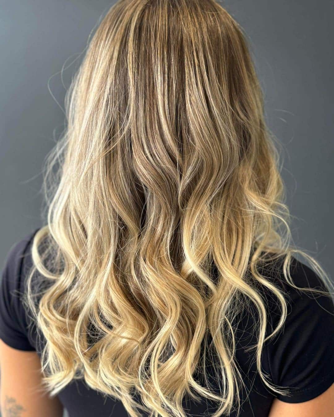 A Woman With Long Blonde Hair is Wearing a Black Shirt β Glam Hair and Beauty in Woy Woy, NSW