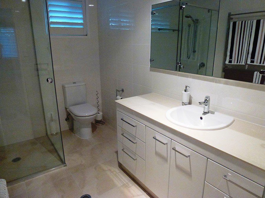 toilet and basin with cabinets under