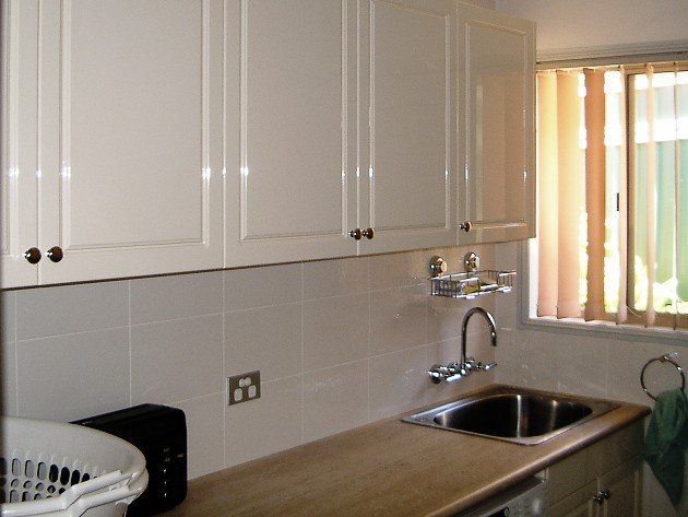 sink with white cabinets on top