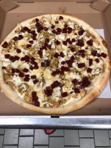 A pizza with a lot of toppings 