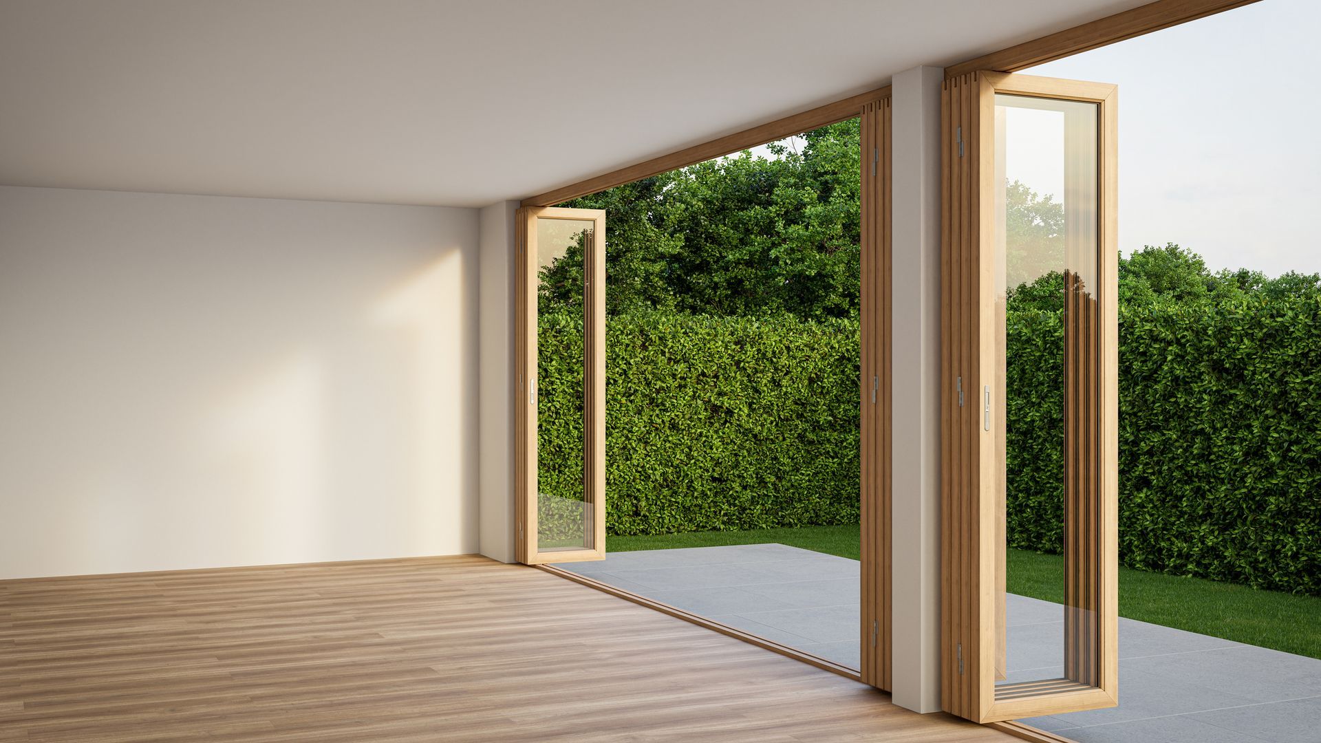 An empty room with sliding glass doors leading to a patio.