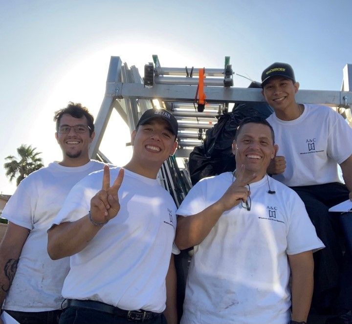 A group of men are posing for a picture with a ladder in the background