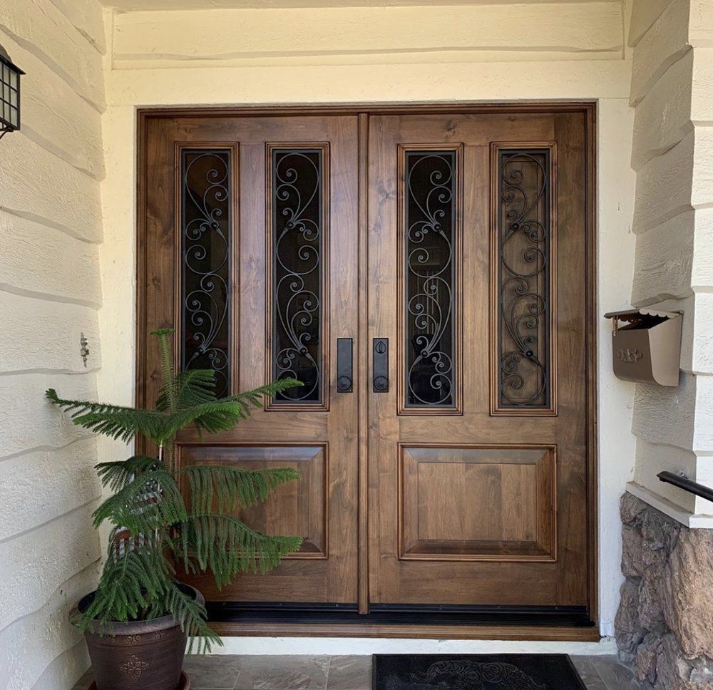 A potted plant sits in front of a wooden door