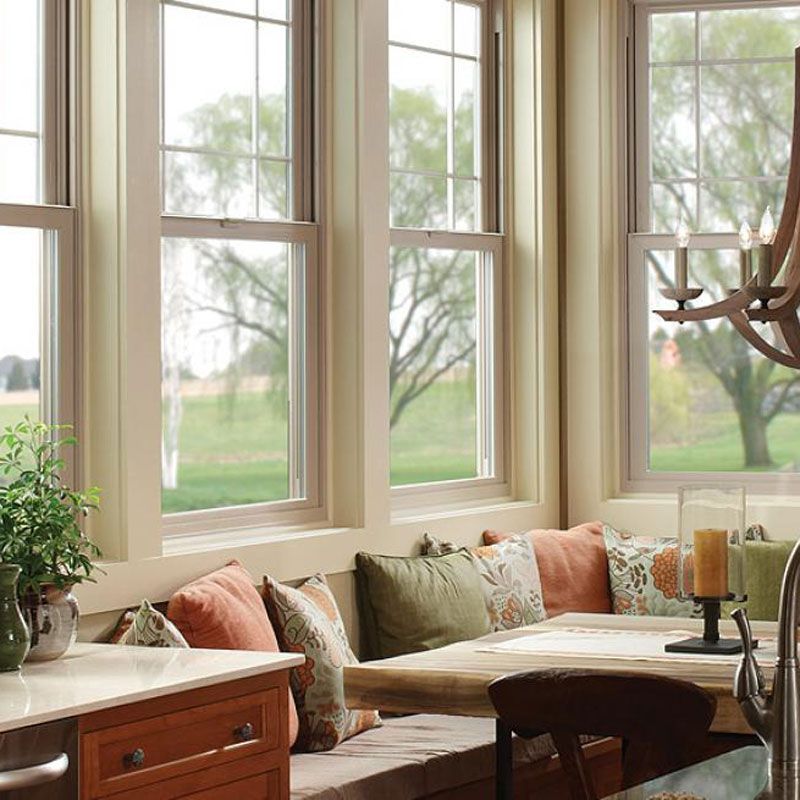 A kitchen with a bench and lots of windows