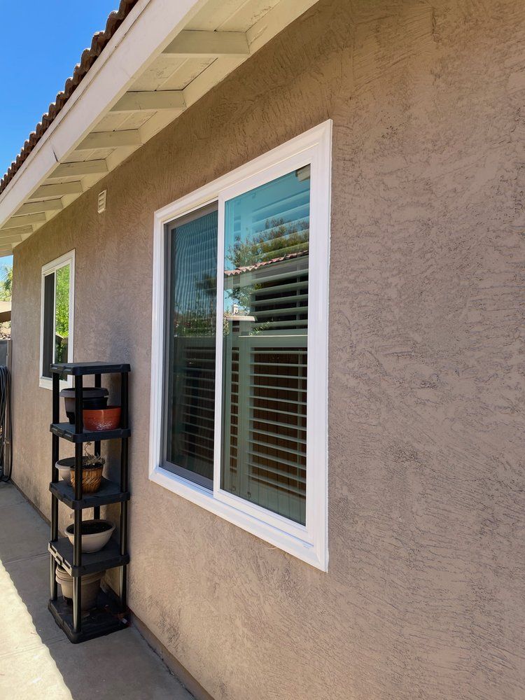 A house with a window and a shelf on the side