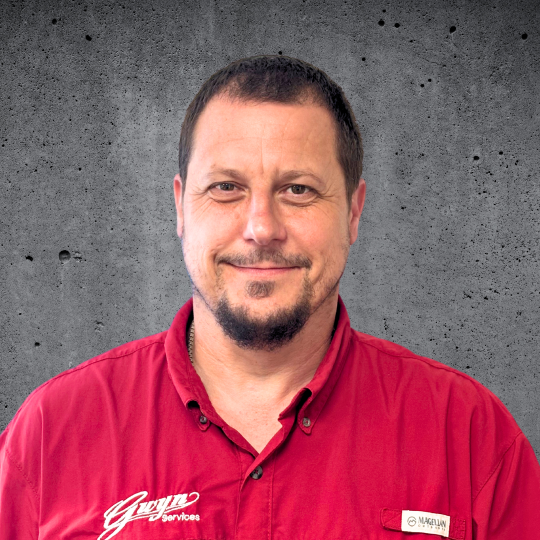 A man with a ponytail is wearing a black and red shirt.