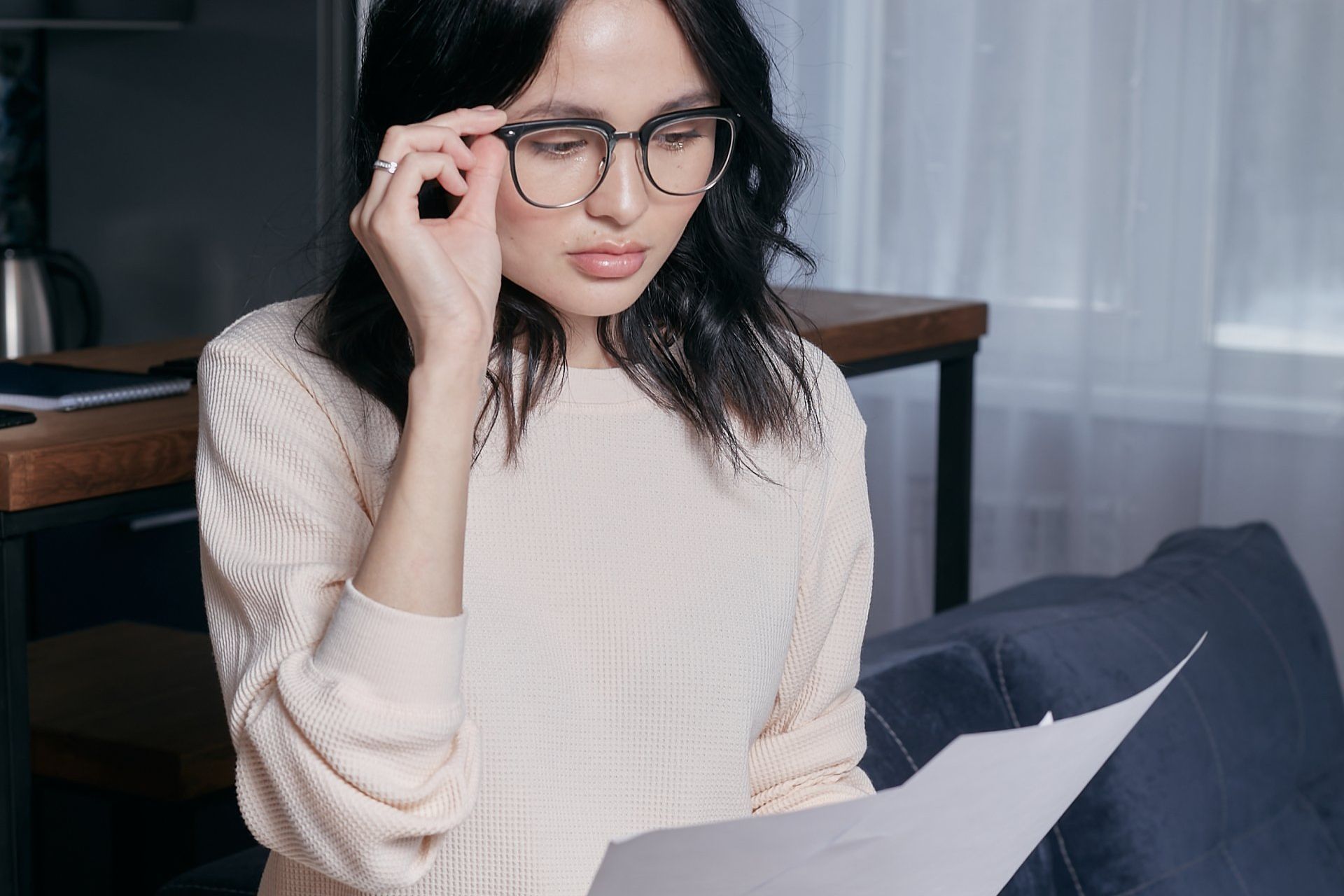 Image of a woman reading a tax file at Planning and Taxes