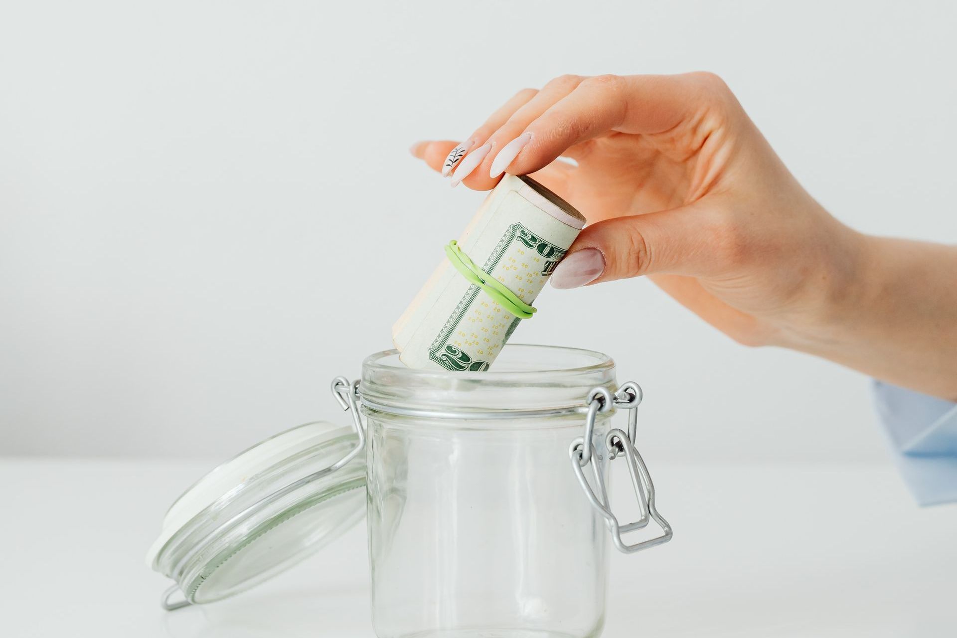 Image of an empty jar and a rolled money representing tax savings at Planning and Taxes