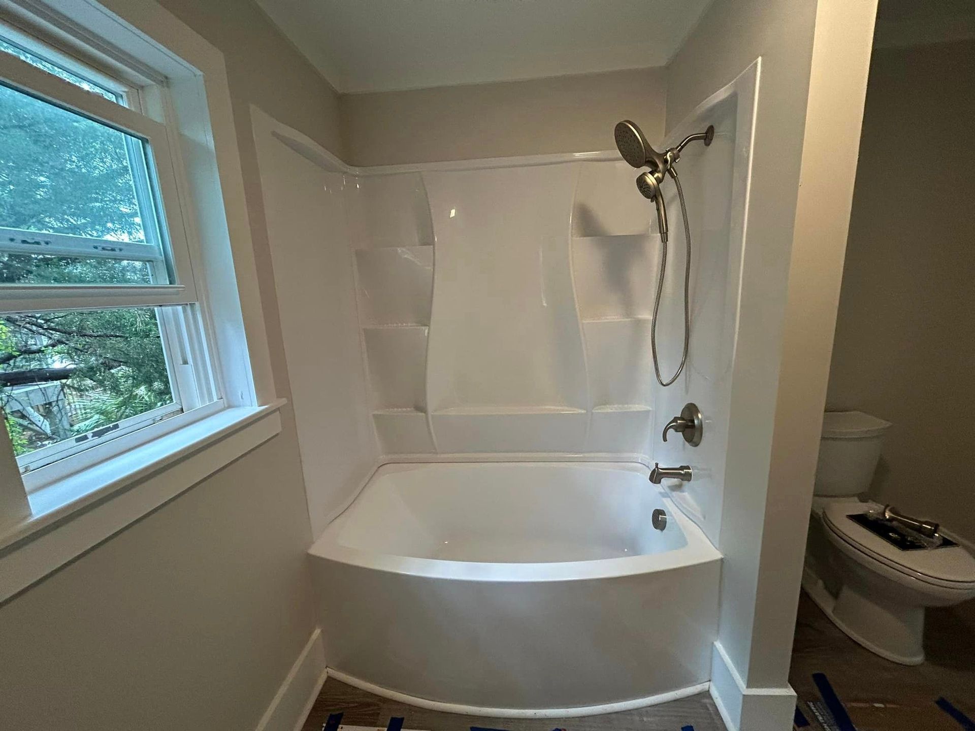 A bathroom with a bathtub and a toilet.