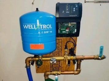 Three pressure gauges are sitting on top of a metal pipe.