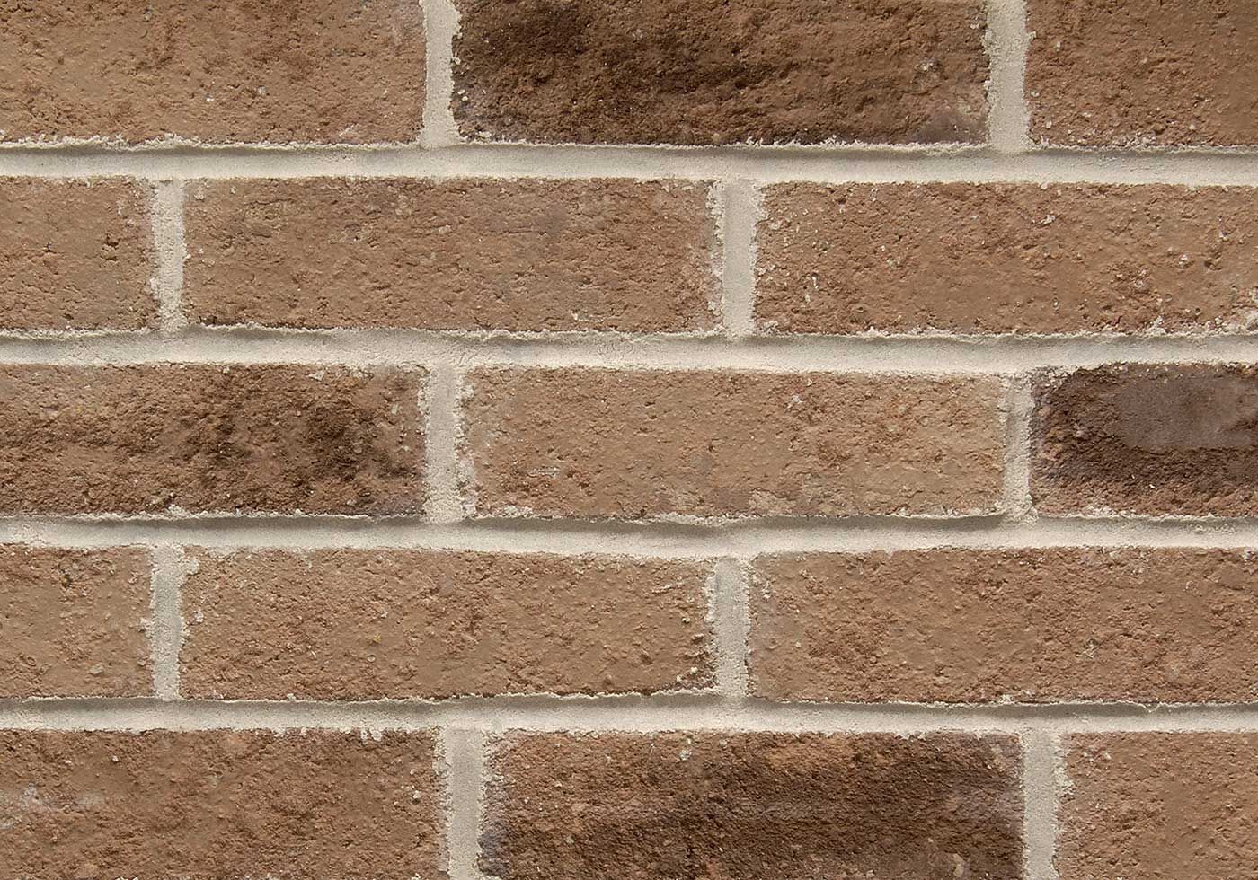 Brown brick wall with light-colored mortar.