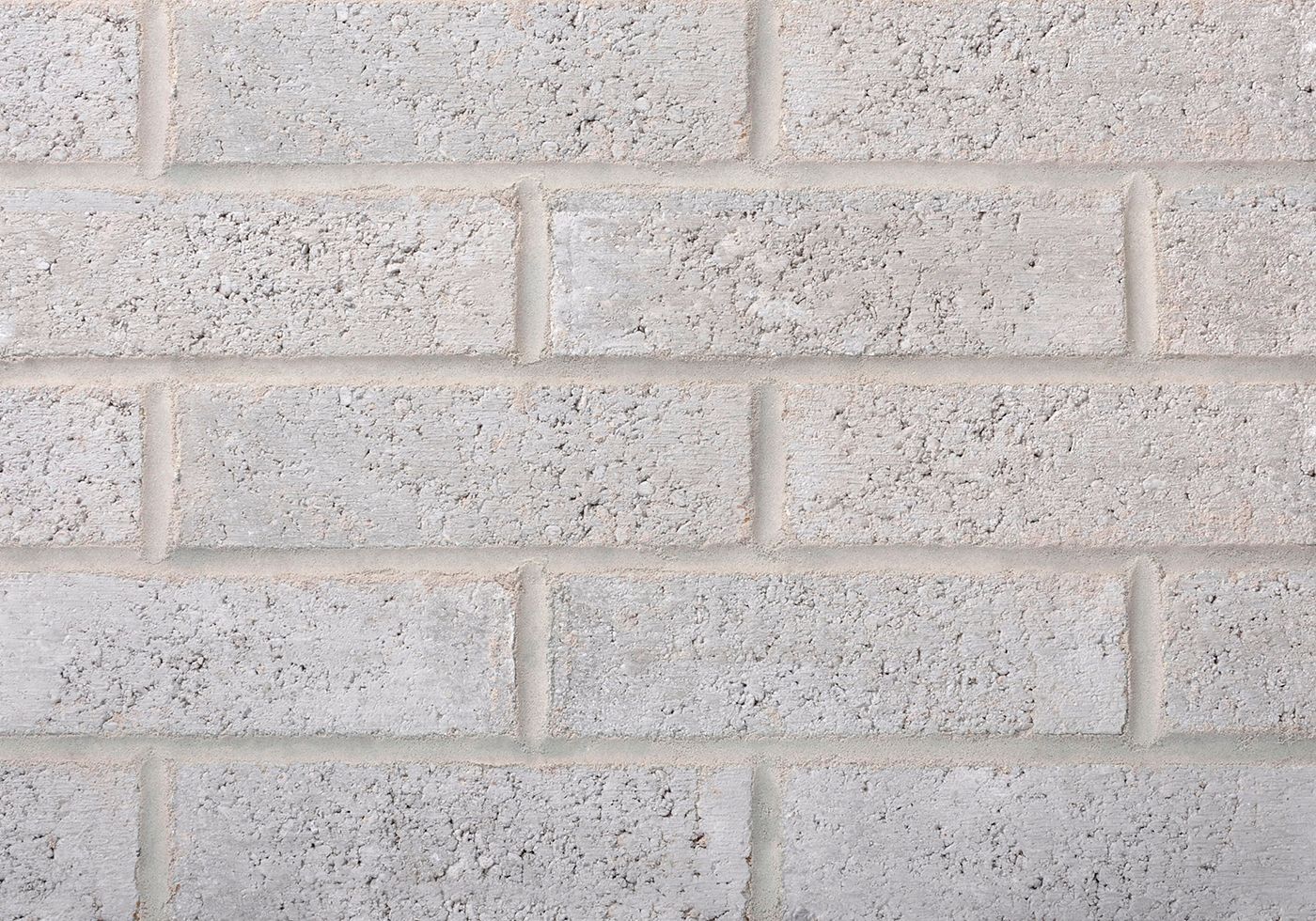 Gray concrete block wall with mortar joints.