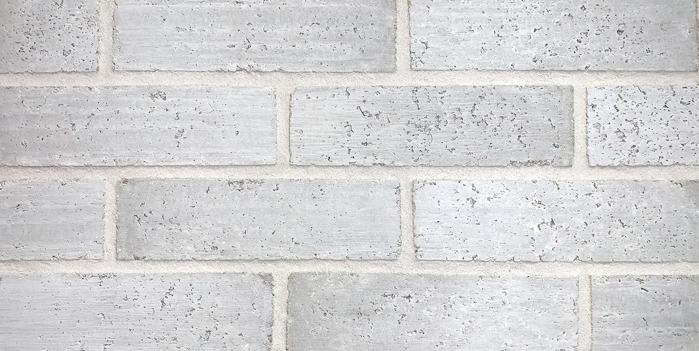 Gray brick wall with white mortar.