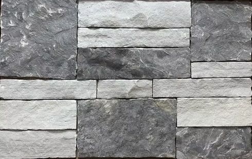 Close-up of a wall made of gray and light gray rectangular stones.