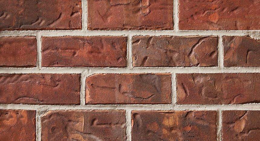 Red brick wall with white mortar.