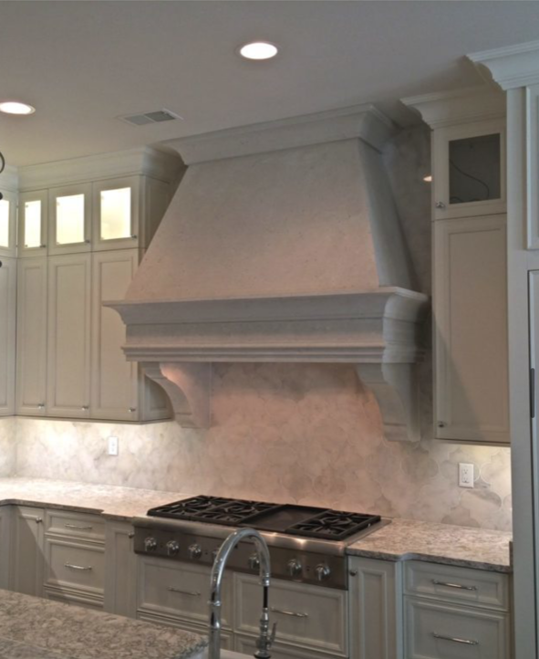 Kitchen with a range hood over a stovetop.