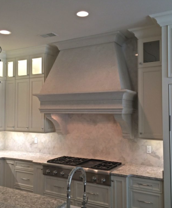 Kitchen with a white range hood, stovetop, and gray cabinets.